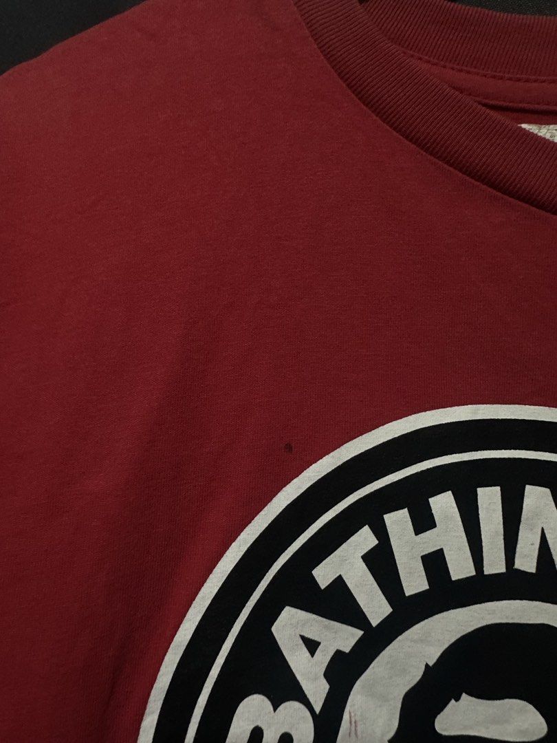 BAPE x Chocoolate Circle Seal Ape Head Tee (Category: Tshirts & Polo Shirts ) located in Buenavista. Submitted by themodernrack (Listing ID 1460893845, Image 3). Description: Brand: A Bathing Ape (BAPE) x Chocoolate Color: Red Style: Short Sleeve Graphic Tee (Features circular “Bathing Ape Chocoolate” seal logo print on front) Tag Size: XL (Fits approx. 21” x 29”, see measurements) Condition: Fair used condition (Needs washing; features faint sur