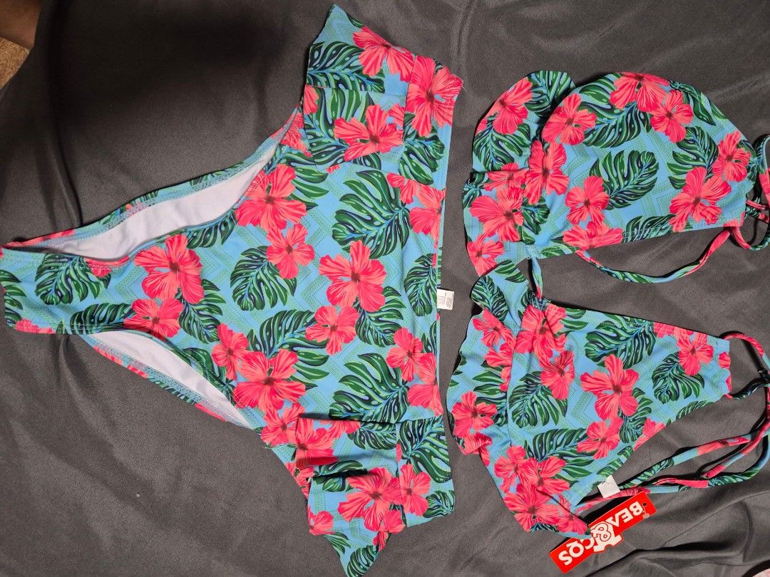 BEACOOS Tropical Floral Bikini Set (Category: Bikinis & Swimsuits) located in Santo Tomas. Submitted by bellaswann18 (Listing ID 1460815907, Image 2). Description: - Adorable tropical print bikini featuring hibiscus flowers and monstera leaves. - Halter neck bikini top with charming ruffled trim. - Matching high-waisted bikini bottoms. - Adjustable ties ensure a comfortable and secure fit. - Perfect for your next beach day or pool party!.