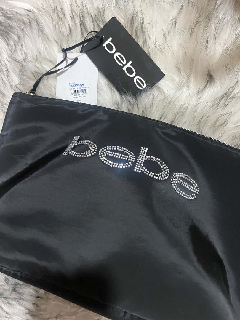 Bebe Rhinestone Logo Pouch (Category: Purses & Pouches) located in Quezon City. Submitted by tugz_ph02 (Listing ID 1460748861, Image 1). Description: - Chic black Bebe pouch - Features a sparkly rhinestone logo - Comes with original tags attached - Perfect size for makeup, essentials, or as a clutch - Easily fits inside your larger handbag.
