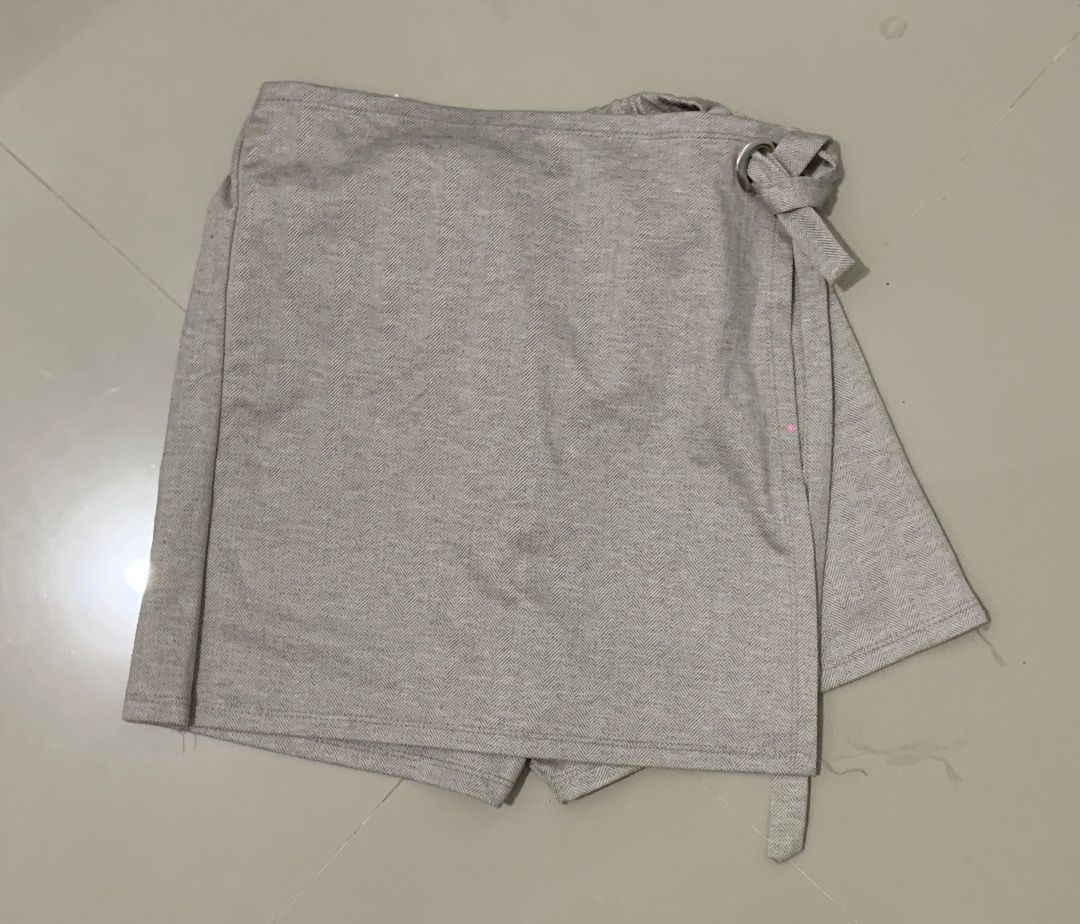 Beige Herringbone Wrap Skirt with D-ring Detail (Category: Skirts) located in Caloocan City. Submitted by missymisskz (Listing ID 1460899619, Image 1). Description: - Chic beige wrap skirt - Subtle herringbone pattern - Convenient side tie closure with D-ring detail - Features built-in shorts for comfort and modesty - Versatile for casual outings or elegant occasions.