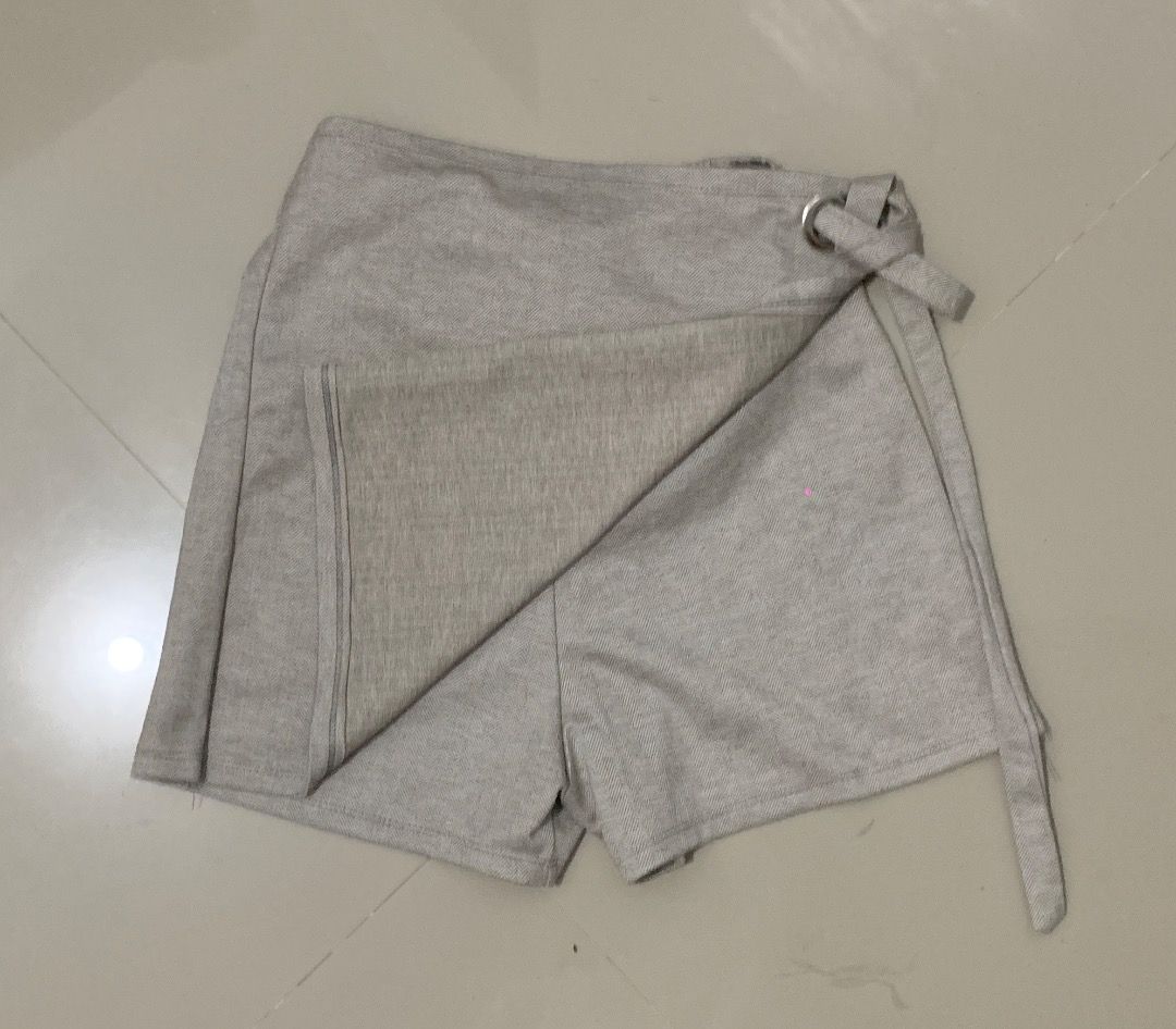 Beige Herringbone Wrap Skirt with D-ring Detail (Category: Skirts) located in Caloocan City. Submitted by missymisskz (Listing ID 1460899619, Image 2). Description: - Chic beige wrap skirt - Subtle herringbone pattern - Convenient side tie closure with D-ring detail - Features built-in shorts for comfort and modesty - Versatile for casual outings or elegant occasions.