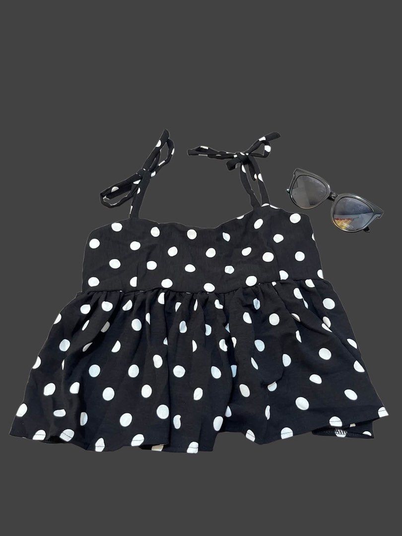 Black and White Polka Dot Tie Strap Top (Category: Sleeveless) located in Cabuyao City. Submitted by 2fa63c18159f66dd6009285b88b3f7 (Listing ID 1460719124, Image 1). Description: - Cute black top with white polka dots - Features adjustable tie straps on the shoulders - Ruffled hemline for a feminine touch - Versatile: pairs well with shorts or jeans - Ideal for casual outings or beach trips - Comfortable and easy to style ྀིྀི MOP: Gcash/ GoTyme/