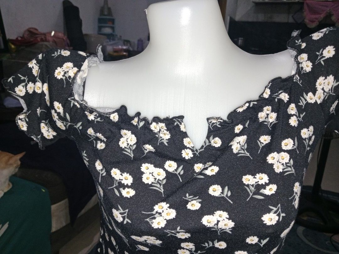 Black Daisy Off-Shoulder Ruffle Mini Dress (Category: Dresses) located in Marilao. Submitted by grace-frugalfoodieph (Listing ID 1460745290, Image 3). Description: - Cute black mini dress - Daisy floral print - Off-shoulder neckline with ruffle trim - Short puff sleeves with ruffles - Bodycon fit - Versatile for casual or night out styling best fits small to medium - Pairs well with sandals or heelsu.