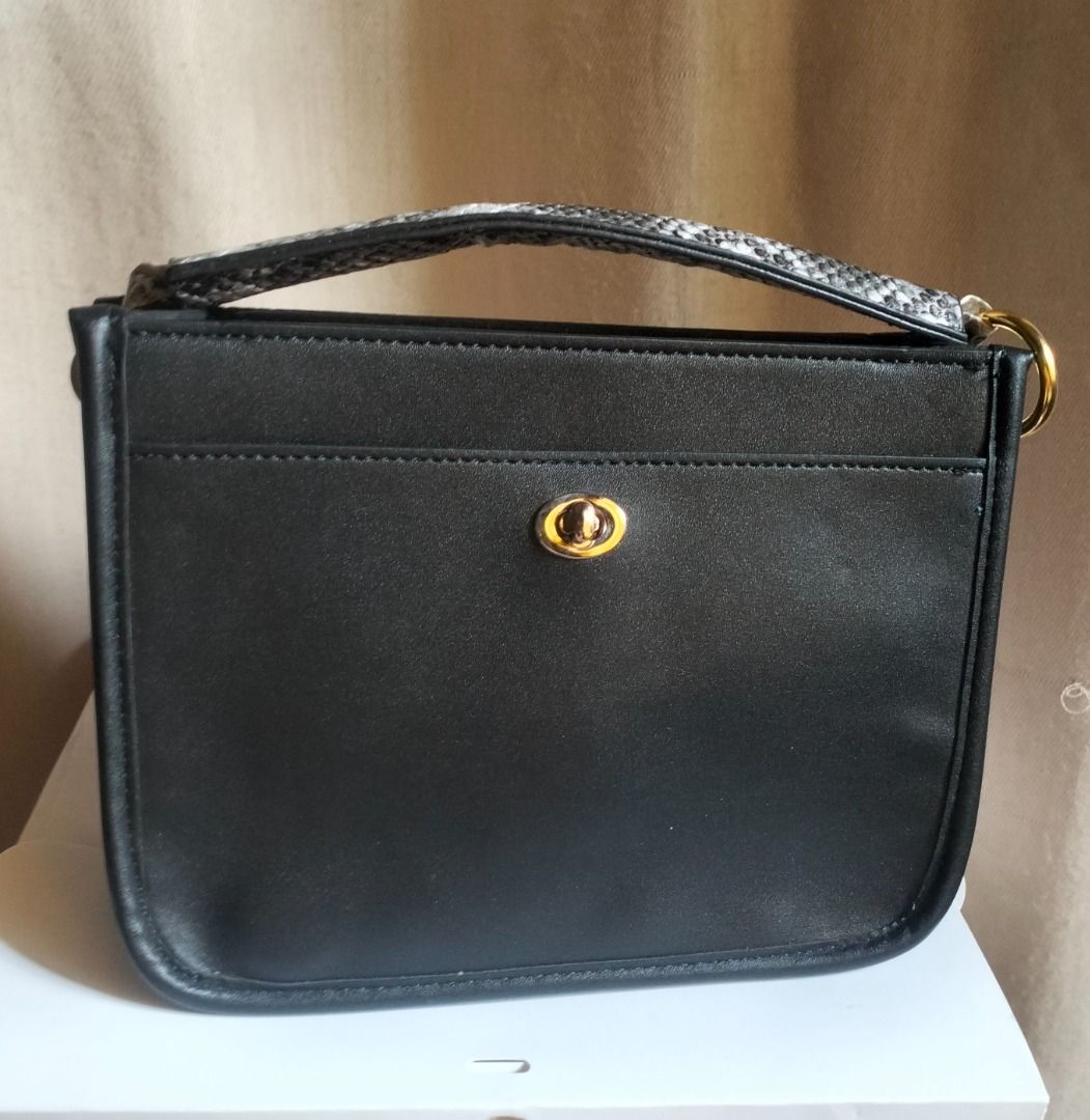 Black Handbag with Snake Print Handle (Category: Luxury Bags & Wallets) located in Caloocan City. Submitted by pretaporter.2026 (Listing ID 1460769467, Image 1). Description: - Unique snake print handle - Gold hardware details - Small front pocket with clasp closure - Ideal for carrying essentials - Versatile style for casual or evening wear -ONCE NAGAMIT, Date Night -Hand Carry Bag (No Strap).