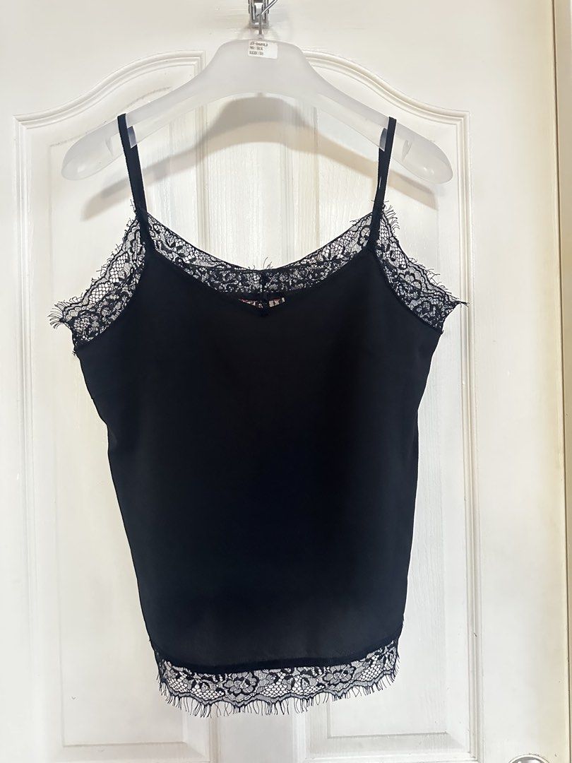 Black Lace Trim Cami Top Spaghetti Straps (Category: Sleeveless) located in Manila. Submitted by nfcloset_ (Listing ID 1460792456, Image 2). Description: - Elegant black cami top - Features delicate lace trim along neckline and hem - Adjustable spaghetti straps - Simple and chic design - Highly versatile: perfect for layering or wearing on its own - Suitable for dressing up or down.