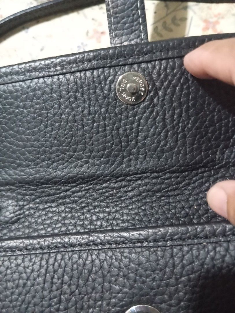 Black Leather Handbag with 'H' Logo (Category: Luxury Bags & Wallets) located in Taguig. Submitted by mavicbien054701 (Listing ID 1460877568, Image 2). Description: - Elegant black leather handbag - Features a prominent 'H' logo on the front flap - Secure magnetic snap closure - Convenient interior zipper pocket - Stylish silver-tone hardware - Adjustable strap for comfortable wear - Exquisitely made in Paris.
