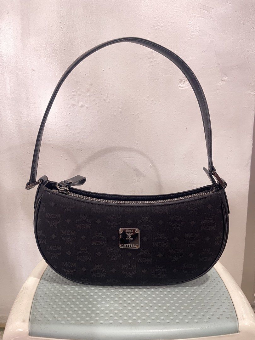 black MCM monogram pochette shoulder bag (Category: Luxury Bags & Wallets) located in Manila. Submitted by john_robert00 (Listing ID 1460893579, Image 1). Description: black MCM monogram pochette shoulder bag Issue : none Pm sa details .