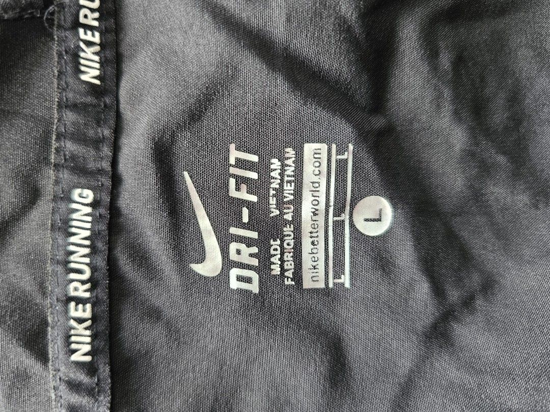 black Nike hooded windbreaker jacket (Category: Coats, Jackets and Outerwear) located in Baguio. Submitted by kayeonlineshop (Listing ID 1460798935, Image 3). Description: -black Nike hooded windbreaker jacket featuring a white Swoosh logo on the chest and contrasting "NIKE PRO" text along the lower right hem -measurements included in the photos.