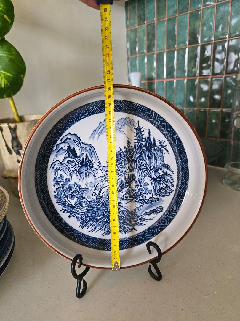 Blue and White Oriental Landscape Decorative Plate (Category: Dinnerware & Cutlery) located in Davao. Submitted by moodsale (Listing ID 1460737004, Image 2). Description: - Stunning blue and white decorative plate - Features intricate oriental landscape design - Subtle copper-colored rim detail - Generous 35cm diameter - Ideal for display or as a unique serving platter.