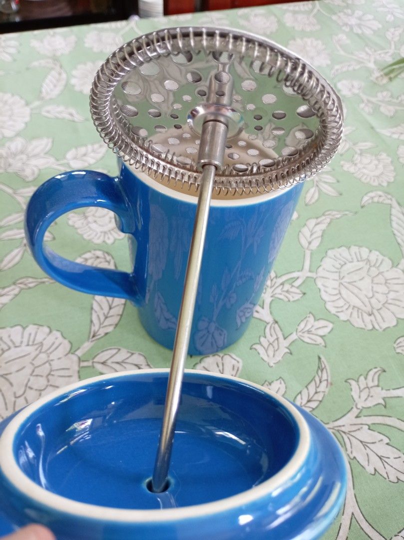 Blue Ceramic French Press (Category: Coffee & Tea Tableware) located in Makati City. Submitted by meowmyella (Listing ID 1460726521, Image 3). Description: - Elegant blue ceramic French press - Comes with a durable stainless steel plunger and lid - Interior is clean white ceramic - Ideal for brewing your favorite coffee or tea - Stands approximately 8 inches tall brand: Cloverleaf England.