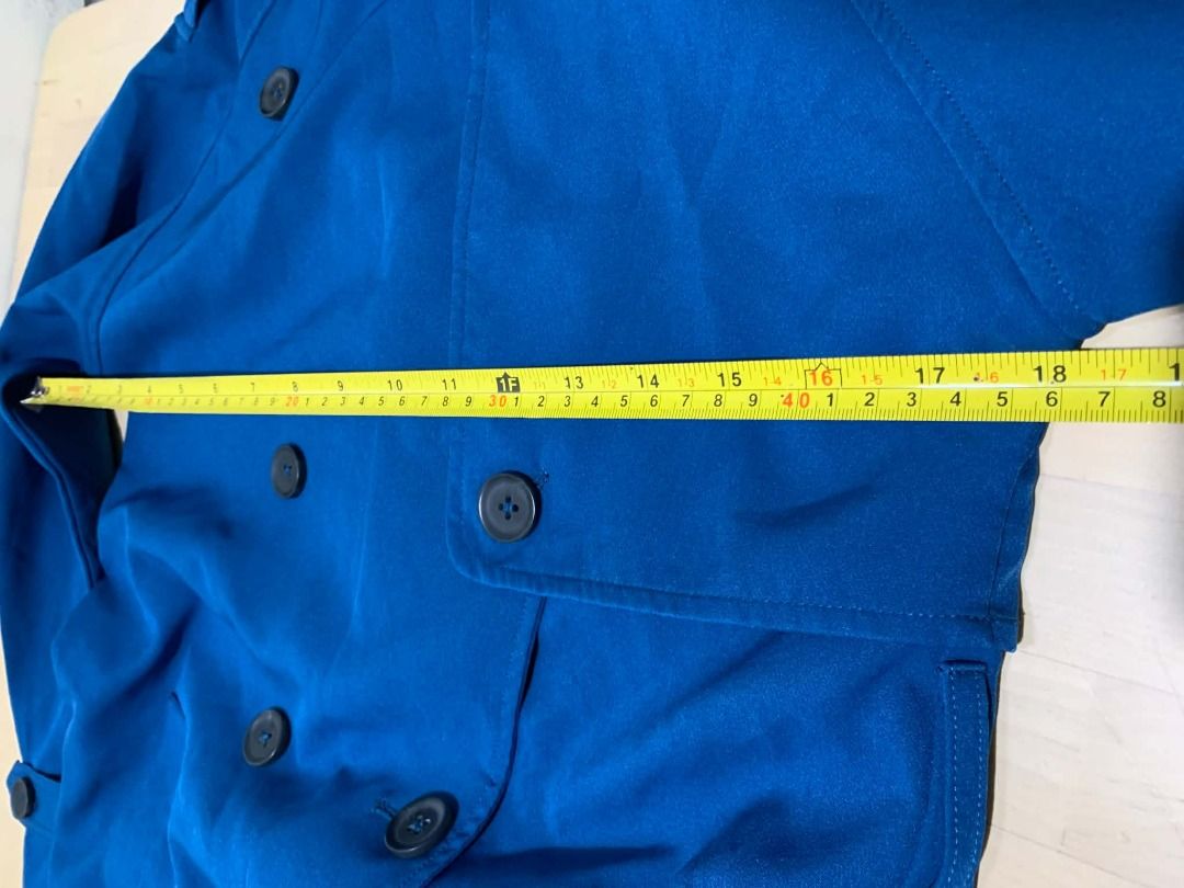 Blue Double-Breasted Trench Coat Small Size (Category: Coats, Jackets and Outerwear) located in Manila. Submitted by musedeclutters (Listing ID 1460806339, Image 3). Description: - Classic blue trench coat - Double-breasted design with button closure - Lapel collar - Buttoned cuffs - Mid-length style - Ideal for layering - Perfect for transitional weather - Without belt - Washed and properly stored before posting 😊.