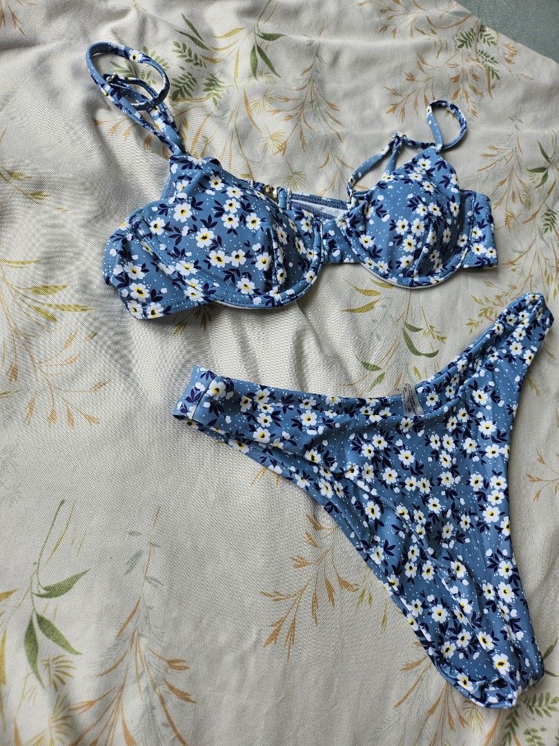 Blue Floral Bikini Set (Category: Bikinis & Swimsuits) located in Pasay City. Submitted by kunin.moto (Listing ID 1460756353, Image 2). Description: Never used. Good quality - Adorable blue bikini - Features a white and yellow floral print - Also includes a fun polka dot pattern - Top has adjustable straps for a perfect fit - Padded - Secure clasp closure on the top - Classic bikini cut bottoms - Ideal for beach days and pool parties.