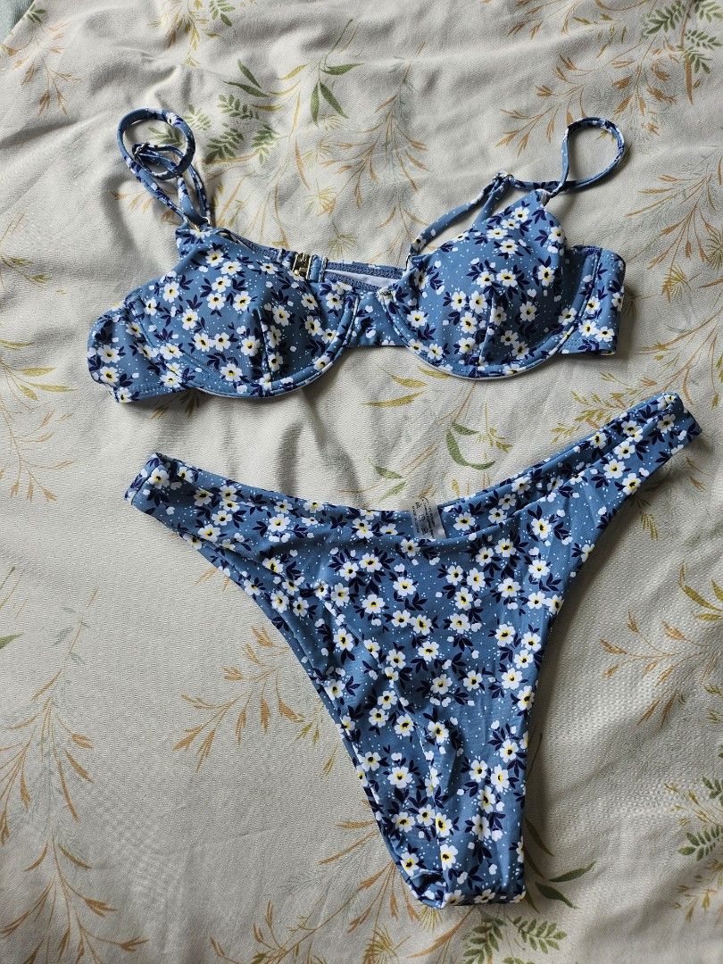 Blue Floral Bikini Set (Category: Bikinis & Swimsuits) located in Pasay City. Submitted by kunin.moto (Listing ID 1460756353, Image 1). Description: Never used. Good quality - Adorable blue bikini - Features a white and yellow floral print - Also includes a fun polka dot pattern - Top has adjustable straps for a perfect fit - Padded - Secure clasp closure on the top - Classic bikini cut bottoms - Ideal for beach days and pool parties.