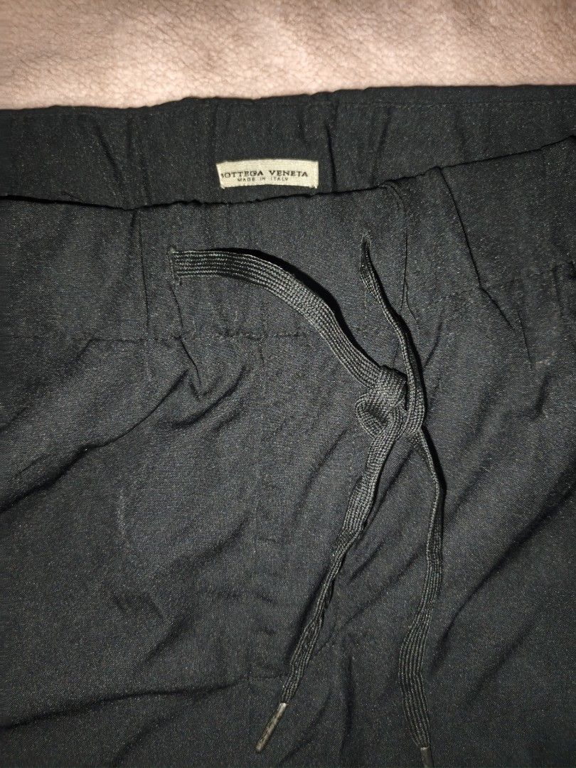 Bottega Veneta Black Drawstring Cargo Pants (Category: Trousers) located in Naga. Submitted by esteemed_shop (Listing ID 1460843651, Image 2). Description: - Black Bottega Veneta pants - Elastic waistband with drawstring - Cargo pockets on the sides - Zipper pockets on the back - Made in Italy - Ideal for casual wear.