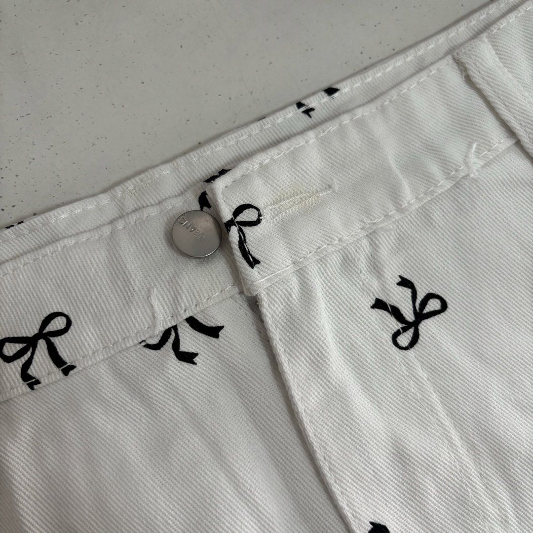 BRAND NEW RIBBON SKIRT (Category: Skirts) located in Manila. Submitted by lexiedeclutters (Listing ID 1460762296, Image 3). Description: - waistline: up to 38” - Brand new white skirt with tags attached - Features a cute all-over black bow print - Functional front and back pockets - Secure button and zip closure.