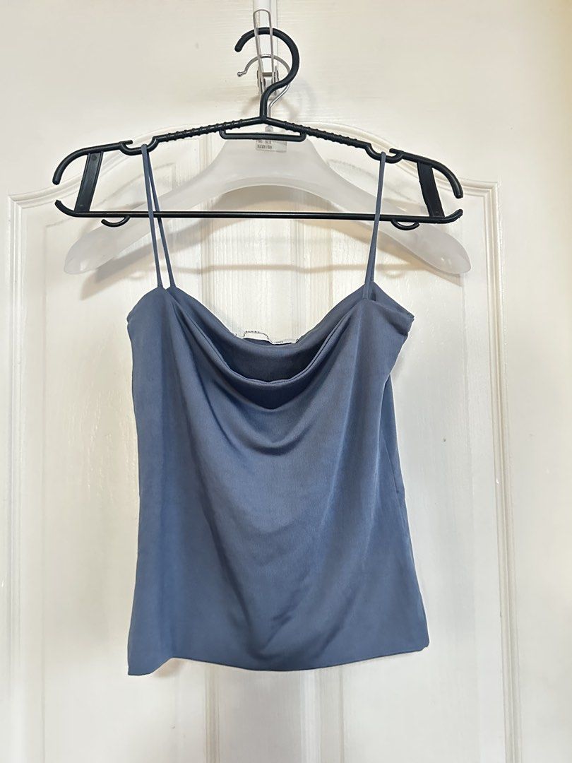 BSCO Blue Cowl Neck Spaghetti Strap Cami Top (Category: Sleeveless) located in Manila. Submitted by nfcloset_ (Listing ID 1460789990, Image 1). Description: - Blue cowl neck cami top - Features delicate spaghetti straps - Made from a smooth, silky material - Highly versatile: dress up or down - Effortlessly pairs with jeans or skirts - A wardrobe essential.