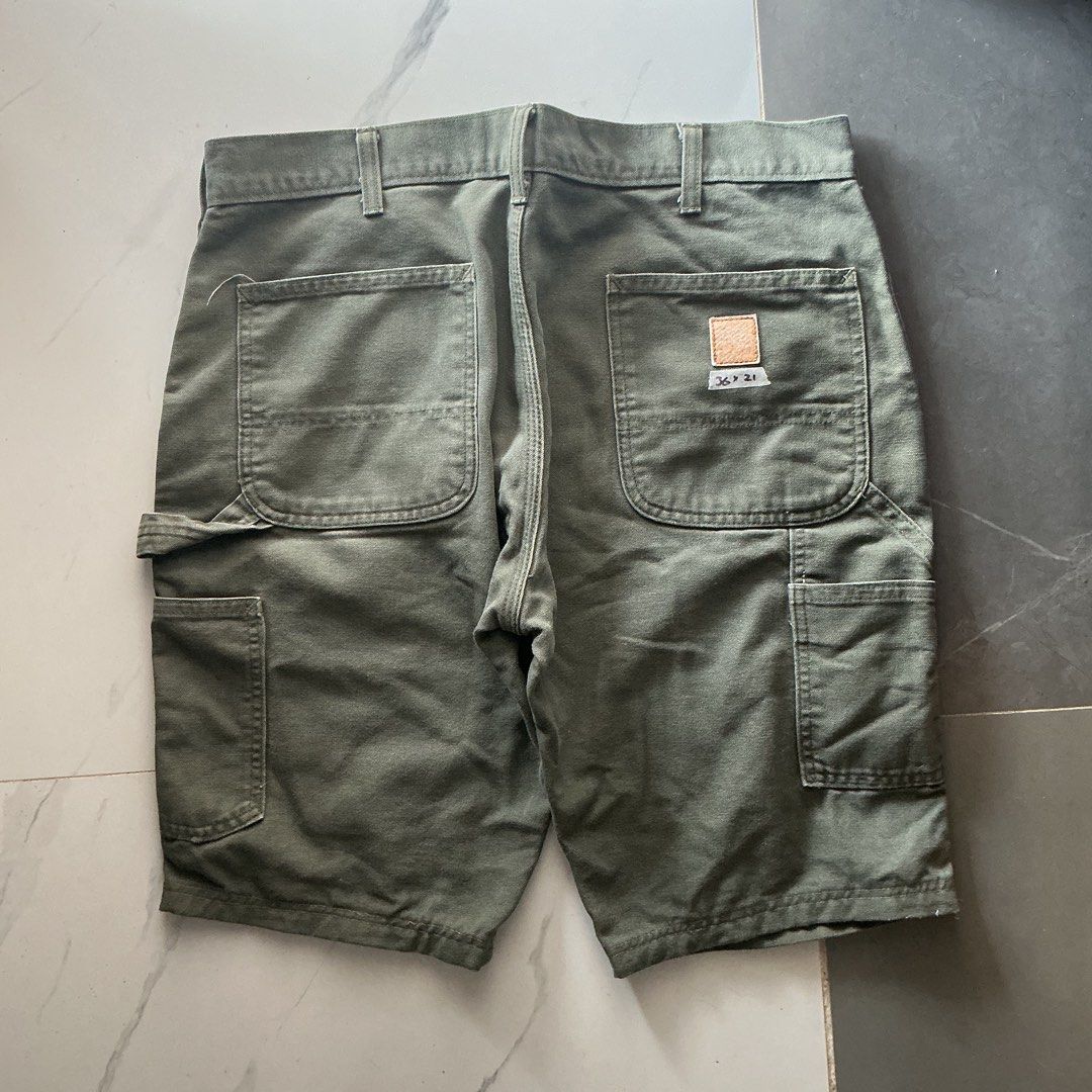 Carhartt Moss Carpenter Jorts (Category: Shorts) located in Santa Barbara. Submitted by evrysundayvintage (Listing ID 1460748942, Image 1). Description: Carhartt Carpenter Jorts Altered length (from pants to jorts) Faded patch Need wash Dimensions Waist: 36” Length: 21” Leg hole: 12”.