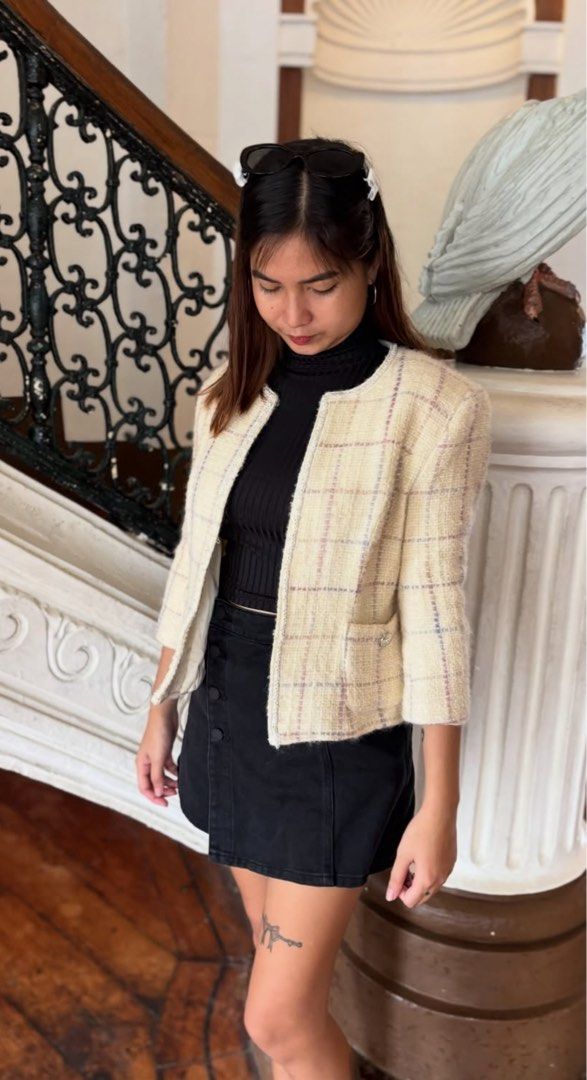 Chanel Tweed Jacket Cream Plaid (Category: Coats, Jackets and Outerwear) located in Alcala. Submitted by dela.sole (Listing ID 1460723614, Image 2). Description: - Authentic Chanel tweed jacket - Elegant plaid pattern with subtle purple and pink threads - Flattering cropped length - Stylish 3/4 sleeves - Two functional front pockets with button details - Smooth, comfortable lined interior - Versatile piece for effortless layering.