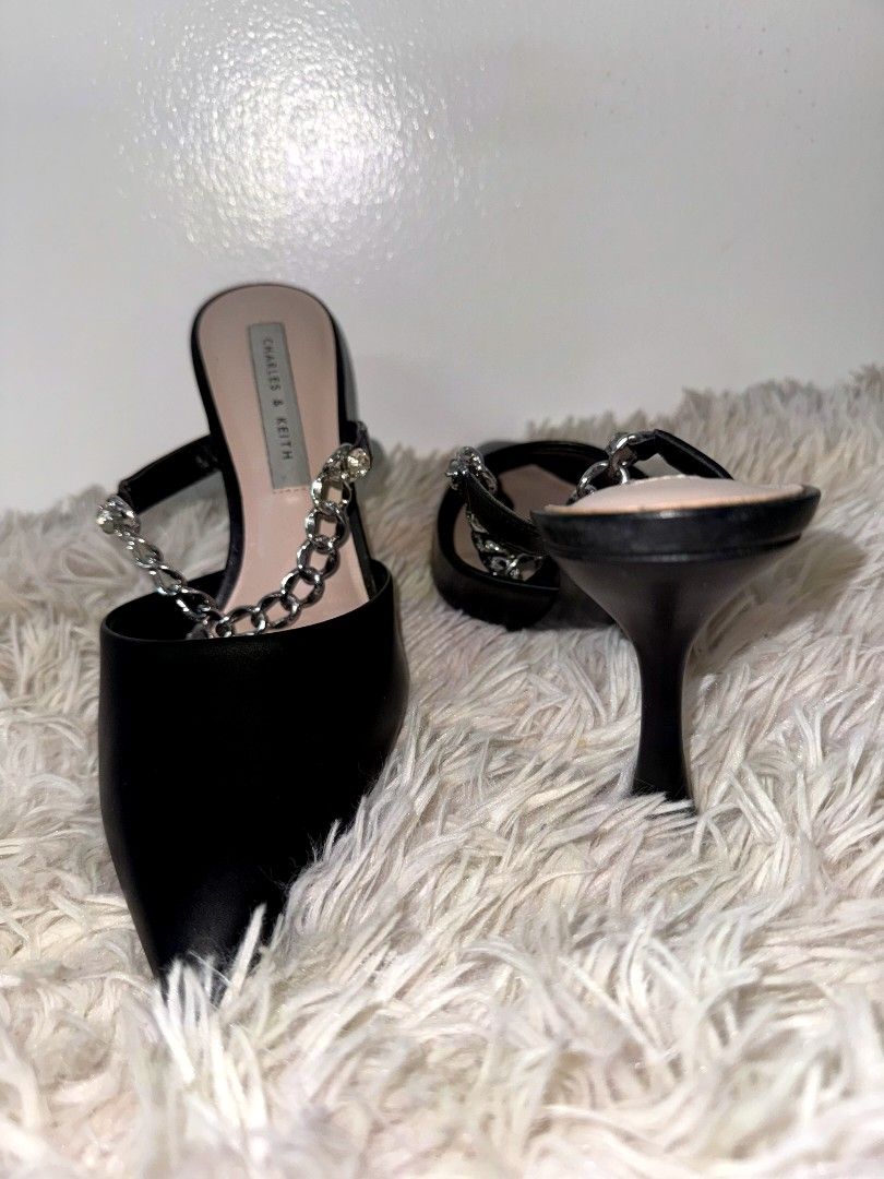 Charles & Keith Black Chain Pointed Toe Heels (Category: Heels) located in Caloocan City. Submitted by mylove326 (Listing ID 1460832536, Image 3). Description: - Brand: Charles & Keith -Original - Style: Black pointed toe mule heels, Leather with silver chain - Feature: Chic chain detail across the front - Design: Easy slip-on style - Condition: Comes with original box and paper bag - Versatility: Great for dressing up any outfit -Good as New.. 1