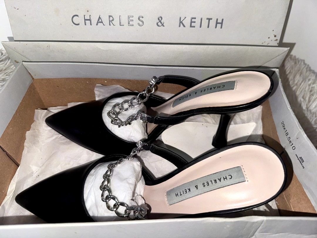 Charles & Keith Black Chain Pointed Toe Heels (Category: Heels) located in Caloocan City. Submitted by mylove326 (Listing ID 1460832536, Image 2). Description: - Brand: Charles & Keith -Original - Style: Black pointed toe mule heels, Leather with silver chain - Feature: Chic chain detail across the front - Design: Easy slip-on style - Condition: Comes with original box and paper bag - Versatility: Great for dressing up any outfit -Good as New.. 1