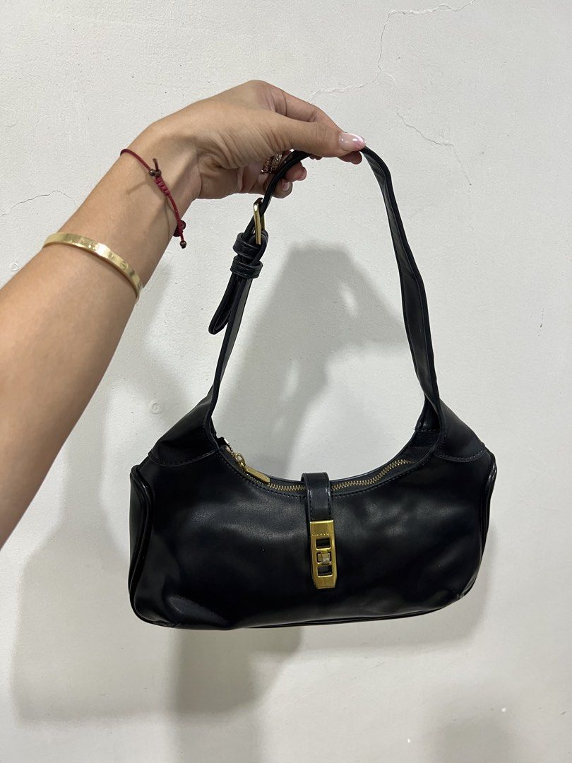 Charles & Keith Black Shoulder Bag with Gold Hardware (Category: Shoulder Bags) located in Digos. Submitted by kathydiane76376 (Listing ID 1460770332, Image 3). Description: - Brand: Charles & Keith - Color: Black - Feature: Gold buckle detail on the front - Closure: Zipper - Strap: Adjustable - Style: Classic and versatile - Occasion: Ideal for everyday use or nights out.