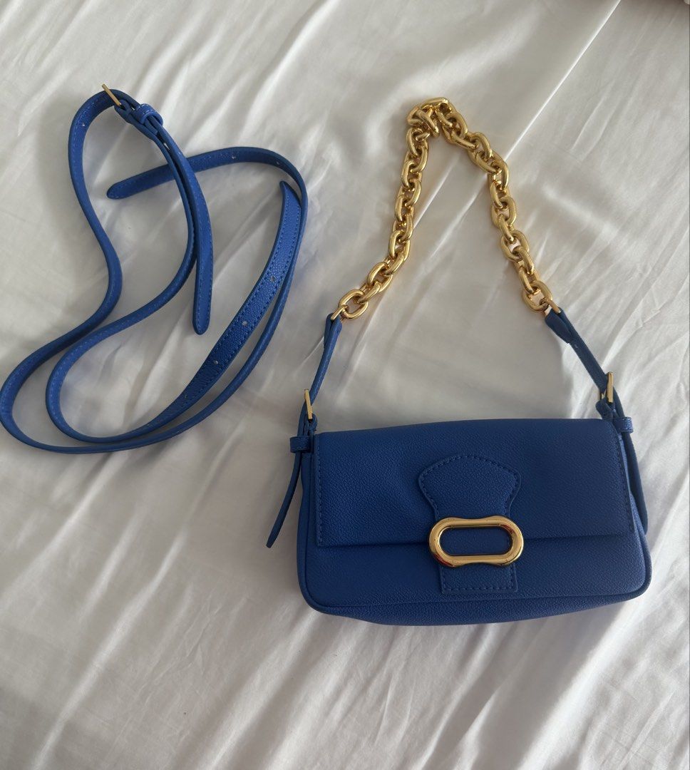 Charles & Keith Blue Shoulder Bag (Category: Shoulder Bags) located in Pasig City. Submitted by angelcstlln (Listing ID 1460737593, Image 1). Description: - Brand: Charles & Keith - Strap: Gold chain strap and detachable blue strap - Interior: Spacious for essentials - Versatility: Ideal for both day and night use.