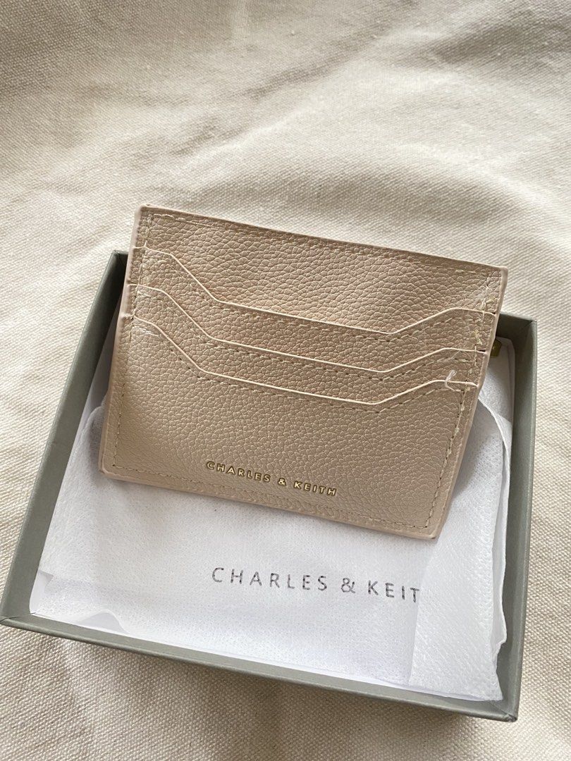 Charles & Keith Card Holder with Zipper Pocket (Category: Wallets & Card holders) located in Iloilo. Submitted by luckyeagle_1c5618 (Listing ID 1460764271, Image 3). Description: - Brand: Charles & Keith - Color: Beige - Material: Pebbled Leather - Features: Multiple card slots (front), Zippered pocket (back) for coins/folded bills - Includes: Original box - Benefit: Keeps essentials organized.