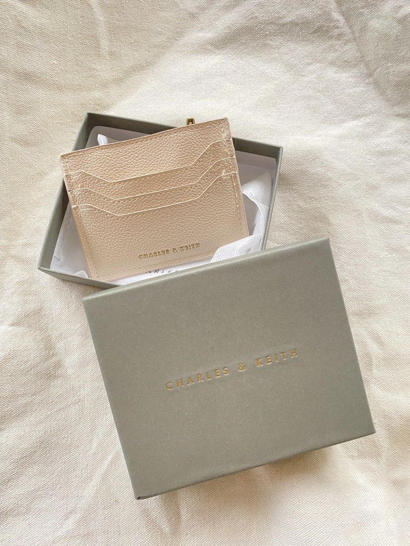 Charles & Keith Card Holder with Zipper Pocket (Category: Wallets & Card holders) located in Iloilo. Submitted by luckyeagle_1c5618 (Listing ID 1460764271, Image 1). Description: - Brand: Charles & Keith - Color: Beige - Material: Pebbled Leather - Features: Multiple card slots (front), Zippered pocket (back) for coins/folded bills - Includes: Original box - Benefit: Keeps essentials organized.
