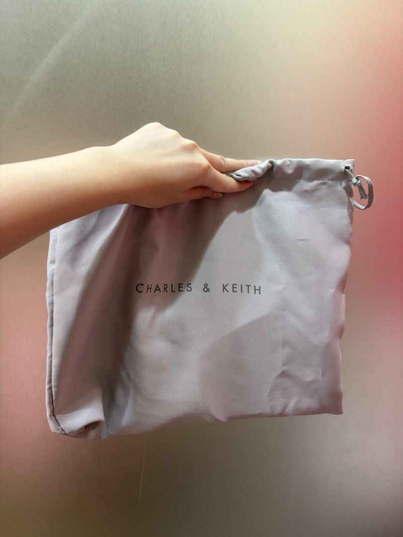 Charles & Keith Dust Bag (Category: Luxury Bags & Wallets) located in Manila. Submitted by curatedclosetbyj (Listing ID 1460763457, Image 1). Description: - Genuine Charles & Keith grey dust bag.