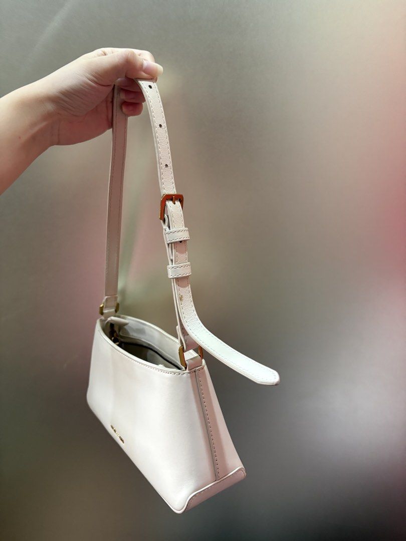Charles & Keith White Shoulder Bag with Gold Hardware (Category: Luxury Bags & Wallets) located in Manila. Submitted by curatedclosetbyj (Listing ID 1460763983, Image 3). Description: - White Charles & Keith shoulder bag - Features a stylish gold buckle detail on the front - NOTE: well used (has lipstick stains inside the bag) .
