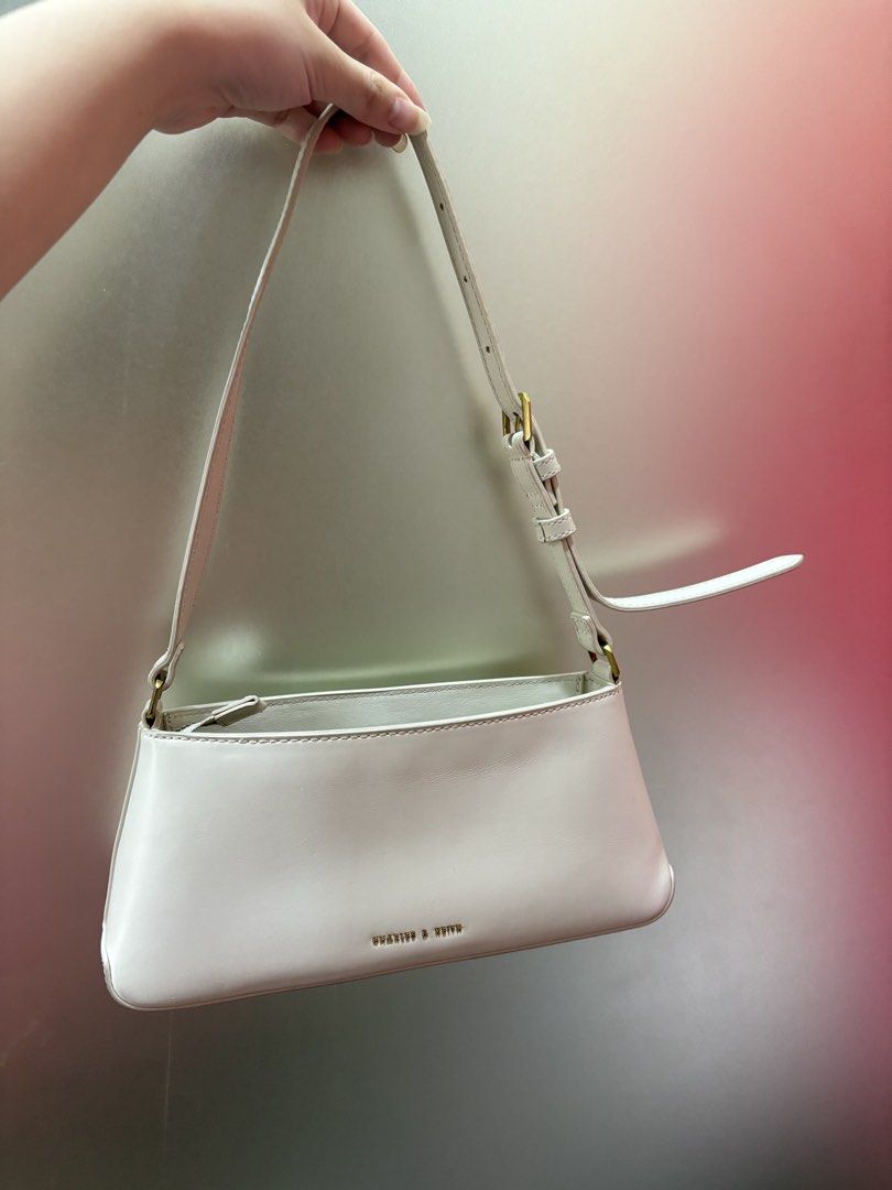 Charles & Keith White Shoulder Bag with Gold Hardware (Category: Luxury Bags & Wallets) located in Manila. Submitted by curatedclosetbyj (Listing ID 1460763983, Image 2). Description: - White Charles & Keith shoulder bag - Features a stylish gold buckle detail on the front - NOTE: well used (has lipstick stains inside the bag) .