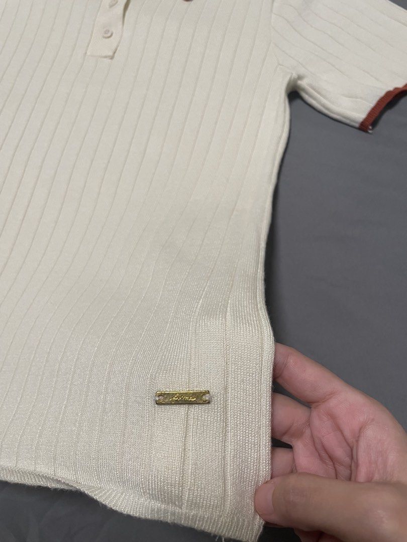 Forme Ribbed Knit Polo Shirt (Category: Blouses) located in Quezon City. Submitted by mfordma (Listing ID 1460884198, Image 3). Description: PRELOVED Doing a little closet decluttering! ✨ Letting go of some preloved pieces that are still in great condition and looking for a new home. 🤍 Brand: Forme Size: Medium Color: Cream Description: - Ribbed soft knit stretchable polo shirt - Features short sleeves and a classic collar with rust colored trim