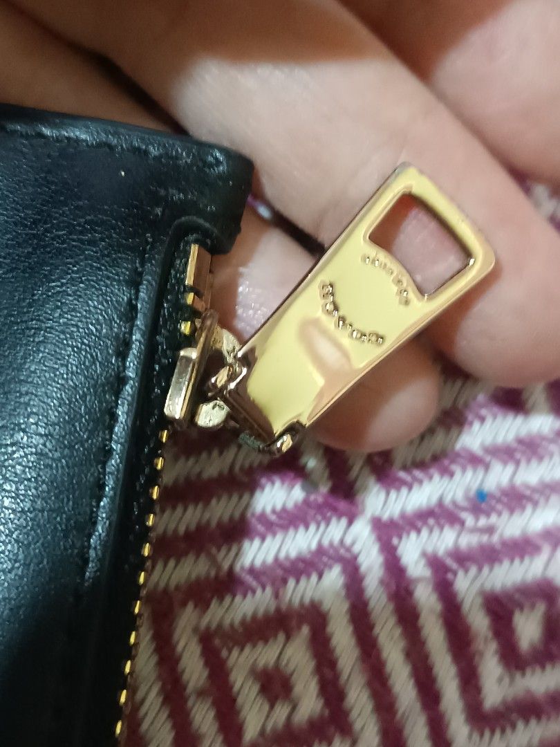 Coach Black Leather Zip Around Clutch Wallet (Category: Luxury Bags & Wallets) located in Las Pinas. Submitted by mitchmiko16 (Listing ID 1460916461, Image 3). Description: - Authentic Coach black leather clutch - Secure zip-around closure with gold hardware - Embossed Coach logo on zipper pull - Spotless interior - Ideal for organizing daily essentials or as a travel pouch.