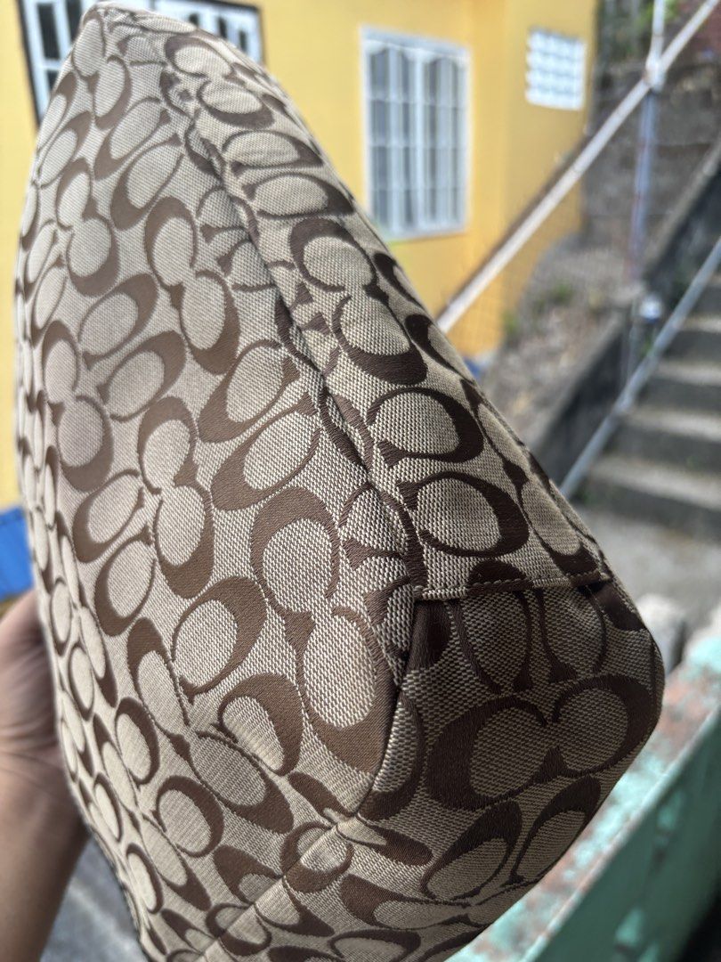 Coach Gallery Signature Tote Bag (Category: Tote Bags) located in Cebu City. Submitted by jhon32closetfinds (Listing ID 1460917082, Image 3). Description: Pattern: Repeating classic "C" signature monogram weave.Hardware: Sturdy silver-tone metal ring connections at the handle base and a central "COACH EST. 1941" metallic logo placard.Details: Distinct pleated accents on the front face and convenient slip pockets situated on both sides.Era: A high