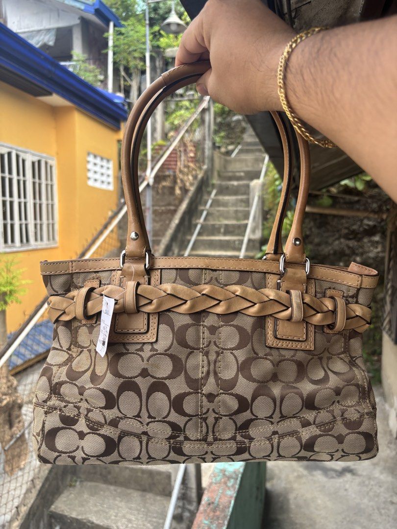 Coach Hampton Signature Carryall (Category: Tote Bags) located in Cebu City. Submitted by jhon32closetfinds (Listing ID 1460775861, Image 2). Description: This appears to be a vintage Coach Hampton Signature Carryall, featuring a classic brown monogram canvas paired with distinctive braided leather buckle accents and a matching tassel..