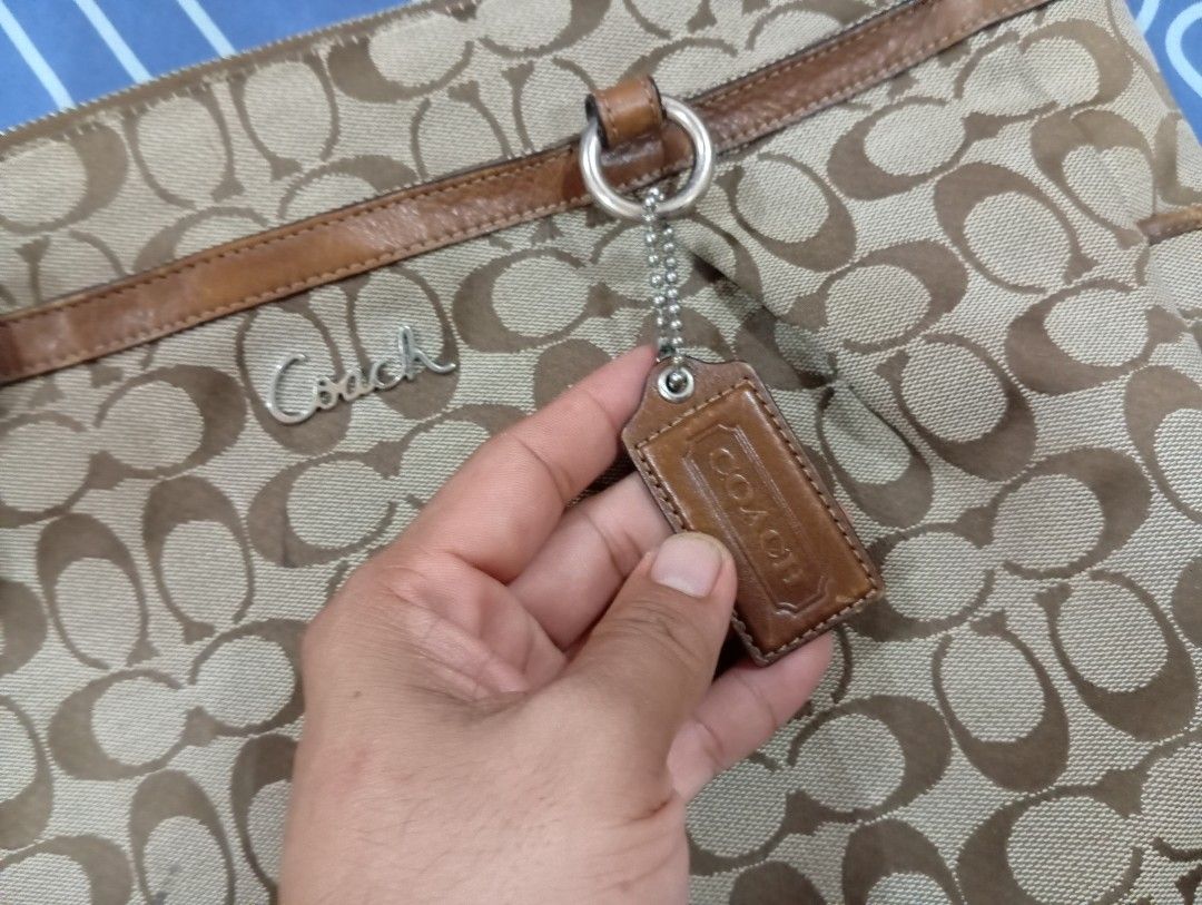 Coach Monogram Canvas Leather Trim Shoulder Bag (Category: Luxury Bags & Wallets) located in Manila. Submitted by jzk25 (Listing ID 1460800858, Image 2). Description: - Authentic Coach shoulder bag - Classic monogram canvas with brown leather trim - Secure zipper closure with a cute leather tag - Interior features a zippered pocket and light purple lining - Spacious enough for all your essentials - Ideal for everyday use missing strap Kaya murag 
