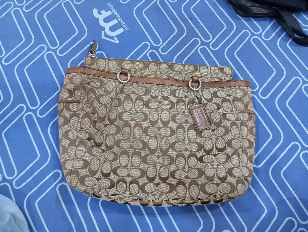 Coach Monogram Canvas Leather Trim Shoulder Bag (Category: Luxury Bags & Wallets) located in Manila. Submitted by jzk25 (Listing ID 1460800858, Image 1). Description: - Authentic Coach shoulder bag - Classic monogram canvas with brown leather trim - Secure zipper closure with a cute leather tag - Interior features a zippered pocket and light purple lining - Spacious enough for all your essentials - Ideal for everyday use missing strap Kaya murag 