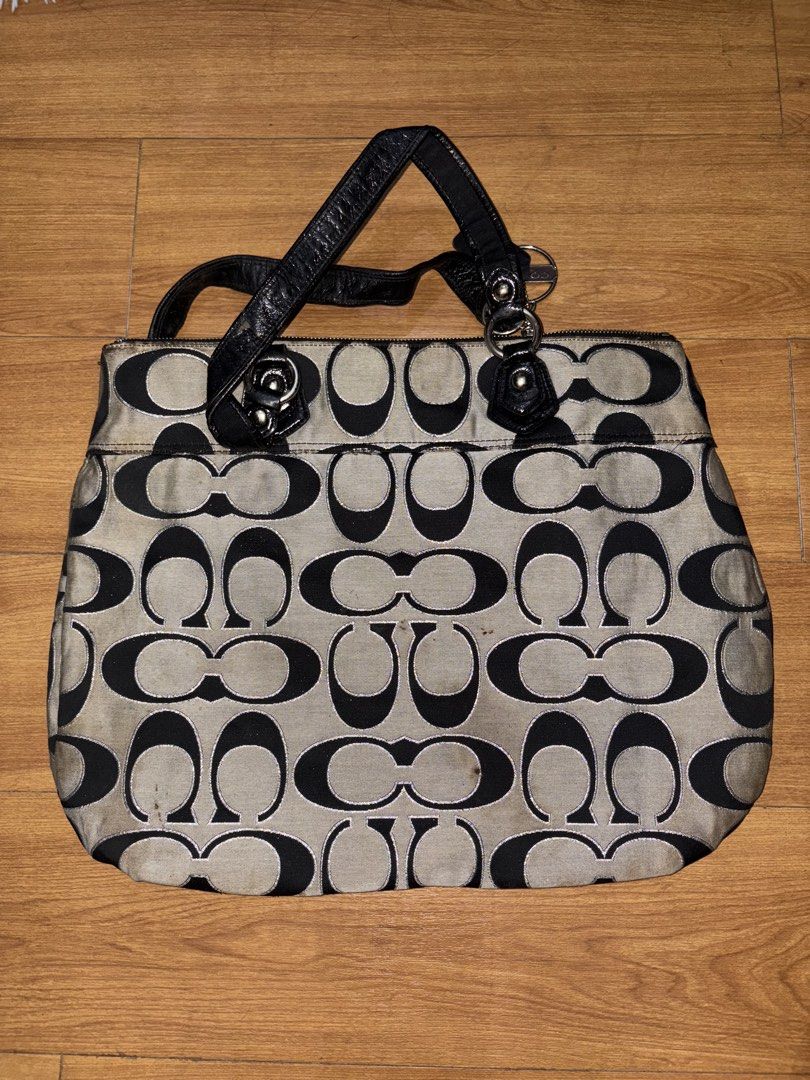 Coach Monogram Canvas Leather Trim Tote Bag (Category: Luxury Bags & Wallets) located in San Pedro. Submitted by maria_xoxo (Listing ID 1460866178, Image 3). Description: - Classic Coach monogram tote - Beige and black canvas with black leather trim - Secure zipper closure on top - Interior pockets for organization - Stylish and spacious everyday bag.