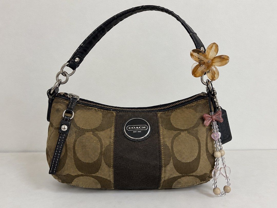 Coach Monogram Shoulder Bag with Charms (Category: Luxury Bags & Wallets) located in Taguig. Submitted by shastaamar44501 (Listing ID 1460737181, Image 2). Description: 🤎 PRELOVED COACH VINTAGE SIGNATURE SHOULDER BAG | ₱2500 Selling my preloved vintage Coach Signature shoulder bag 🤎 Classic brown/tan Signature “C” jacquard canvas with dark brown leather details, Coach logo plaque, silver-tone hardware, and cute floral + beaded charms attached. 