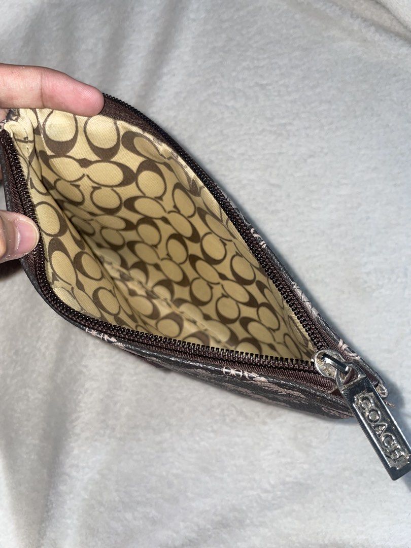Coach Pouch (Category: Luxury Bags & Wallets) located in Bulacan. Submitted by keytxcx (Listing ID 1460879377, Image 3). Description: - Coach pouch with signature horse and carriage print - Interior lining features Coach 'C' pattern - Secure zipper closure - Lost wrist strap - Ideal for organizing essentials or carrying solo - Preloved - No box or dustbag - Price is still negotiable!!! - With freebies - RFS: decluttering - Dm me for more Inquiry 