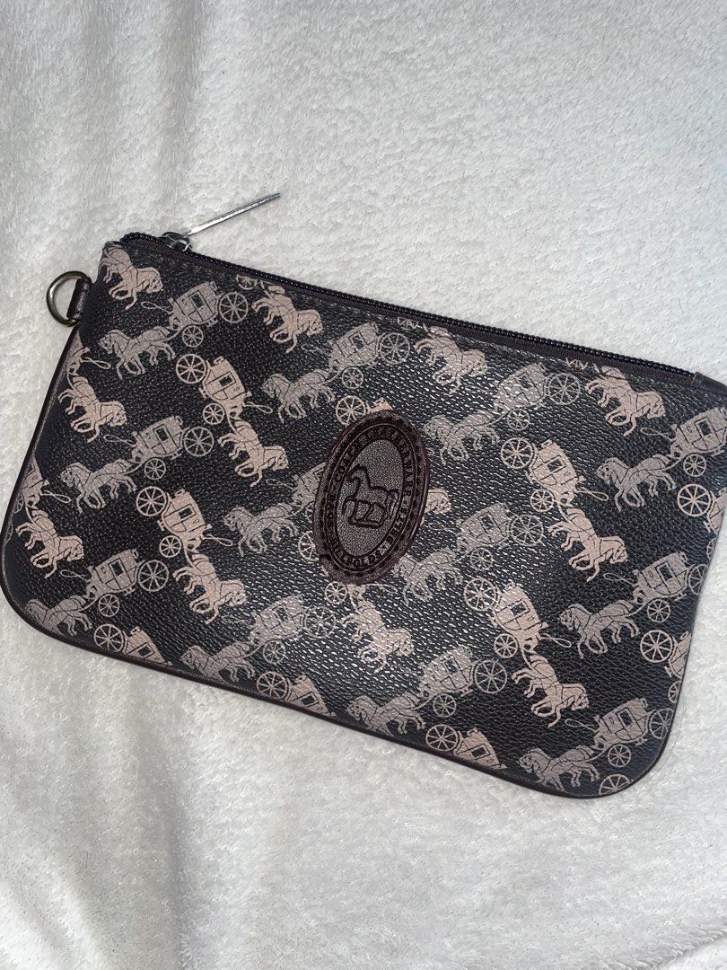 Coach Pouch (Category: Luxury Bags & Wallets) located in Bulacan. Submitted by keytxcx (Listing ID 1460879377, Image 1). Description: - Coach pouch with signature horse and carriage print - Interior lining features Coach 'C' pattern - Secure zipper closure - Lost wrist strap - Ideal for organizing essentials or carrying solo - Preloved - No box or dustbag - Price is still negotiable!!! - With freebies - RFS: decluttering - Dm me for more Inquiry 