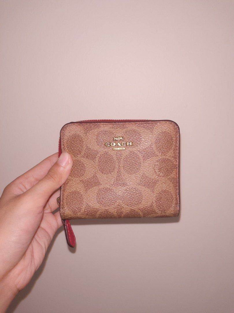 Coach Signature Canvas Zip Around Wallet (Category: Wallets & Card holders) located in Angeles City. Submitted by accountnameundecided (Listing ID 1460749508, Image 1). Description: - Authentic Coach wallet - Signature C pattern in tan and brown canvas - Vibrant red interior - Zip-around closure with red leather pull tab - Compact and pocket-friendly design - Ideal for cards and coins 🚚 Shipping: via Lalamove Shipping Fee: shouldered by buyer Mo