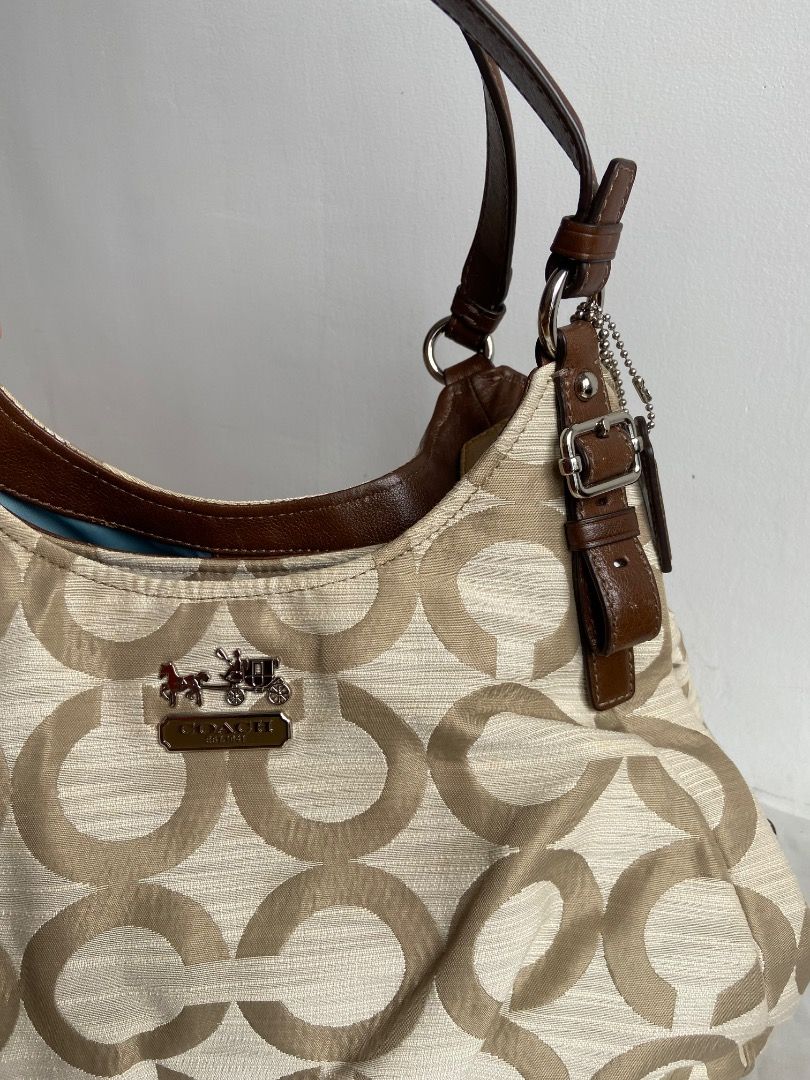 Coach Signature Hobo Bag (Category: Luxury Bags & Wallets) located in Caloocan City. Submitted by _arabellasapparel (Listing ID 1460808777, Image 3). Description: - Coach hobo bag with signature C monogram pattern - Beige and brown colorway - Genuine leather trim and handles - Interior includes pockets and a zip compartment - Secure magnetic snap closure - Ideal for everyday carry 📌 Condition: Good pre-loved condition 📌 Issue: Has minimal signs