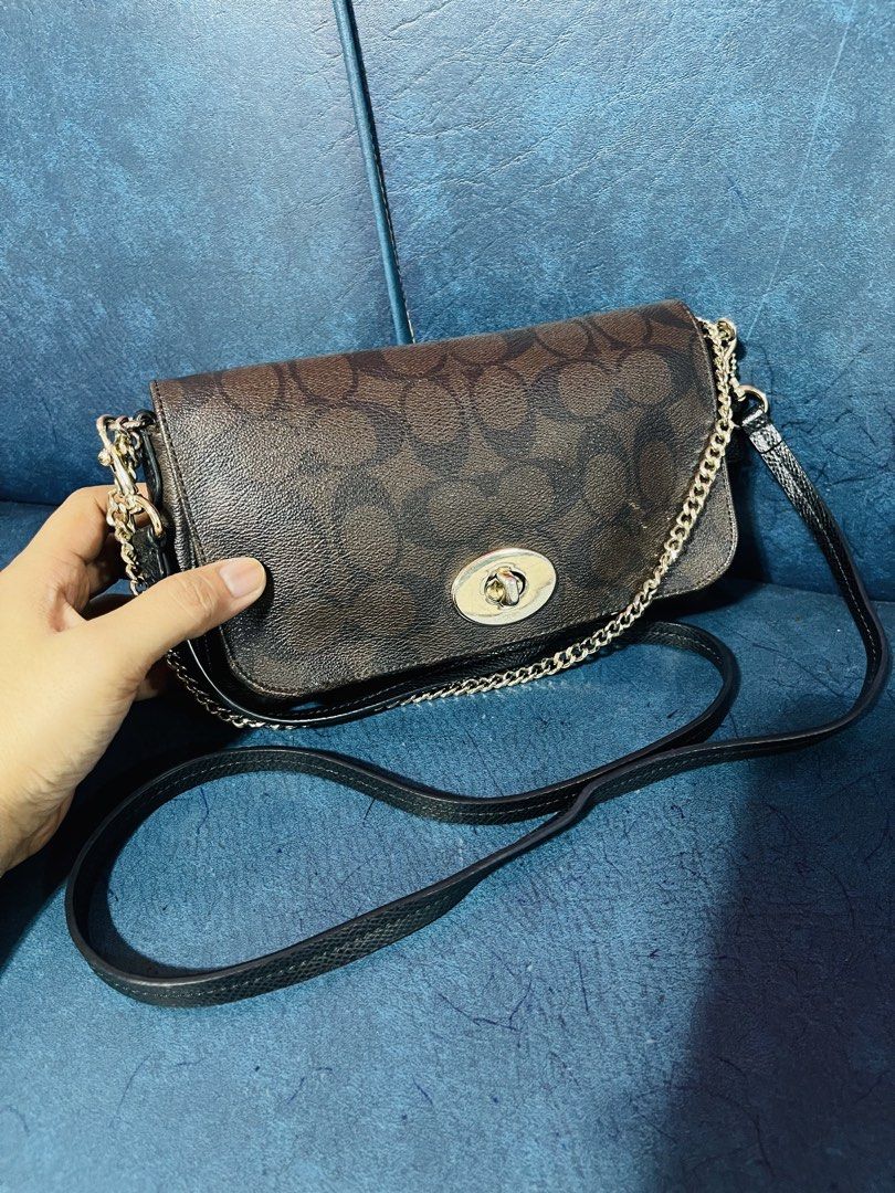Coach Signature Monogram Canvas & Leather Shoulder Bag (Category: Luxury Bags & Wallets) located in Manila. Submitted by lenilynloy68852 (Listing ID 1460898877, Image 2). Description: - Classic Coach monogram canvas shoulder bag - Tan and brown signature 'C' pattern - White leather trim and tan leather accents - Silver hardware with cute charms - Adjustable shoulder strap - Spacious interior for essentials - Stylish everyday bag.