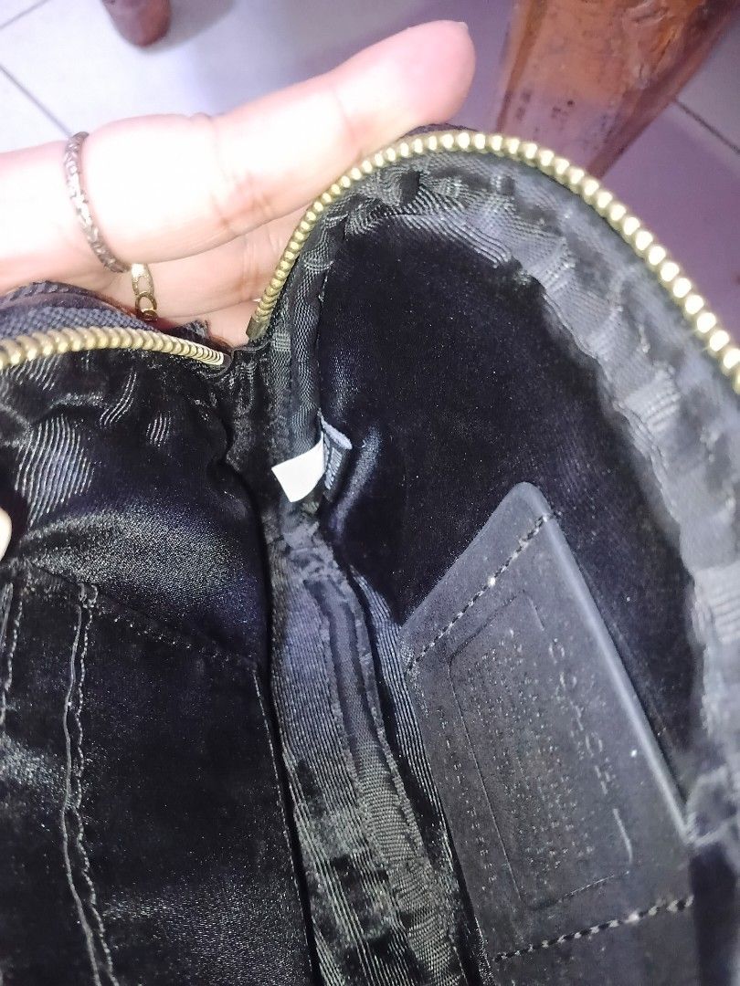 Coach Signature Monogram Sling Bag (Category: Luxury Bags & Wallets) located in Cavite. Submitted by ms.de.clutter (Listing ID 1460793264, Image 3). Description: - Authentic Coach monogram pouch - Color: Black and grey signature pattern - Two separate zippered compartments - Gold hardware details - Interior Coach leather patch and tag - Ideal for organizing essentials.
