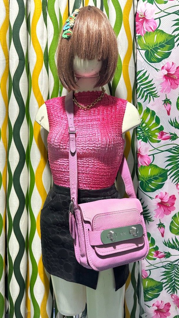 COACH SWAGGER 🩷 (Category: Cross-body Bags) located in Tambulig. Submitted by cmscloset_ph (Listing ID 1460851722, Image 1). Description: - Cute pink Coach crossbody bag - Genuine leather material - Secure turnlock closure - Adjustable strap for comfort - Perfect for everyday or evening use - Spacious interior for essentials - Shows minor signs of wear, still has plenty of life left.