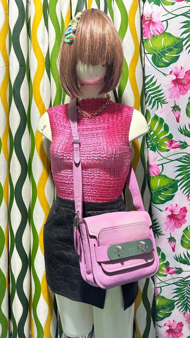 COACH SWAGGER 🩷 (Category: Cross-body Bags) located in Tambulig. Submitted by cmscloset_ph (Listing ID 1460851722, Image 2). Description: - Cute pink Coach crossbody bag - Genuine leather material - Secure turnlock closure - Adjustable strap for comfort - Perfect for everyday or evening use - Spacious interior for essentials - Shows minor signs of wear, still has plenty of life left.