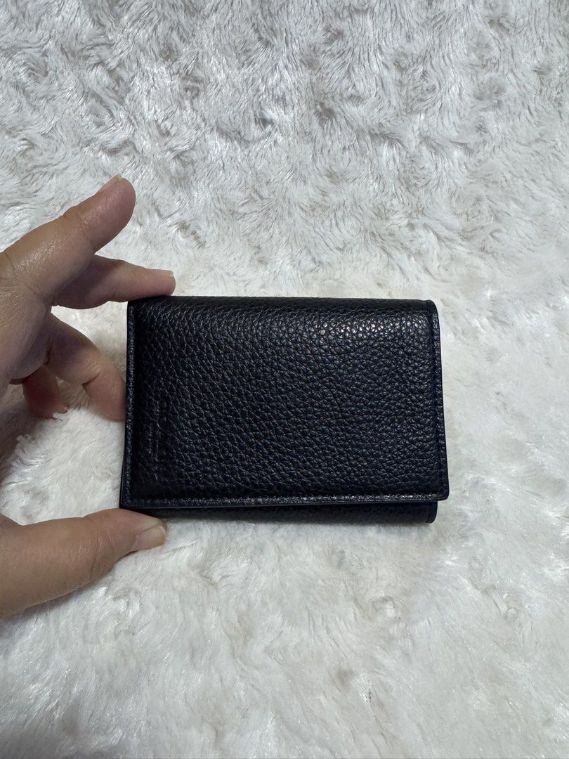 Coach Trifold Wallet Pebble Leather Navy (Category: Wallets & Card holders) located in Carmona. Submitted by outletshopper.ph (Listing ID 1460808630, Image 2). Description: - Black Coach trifold wallet - Made from genuine pebble leather - Ample card slots for organization - Compact and pocket-friendly size - Ideal for everyday use - Interior is clean and well-maintained.