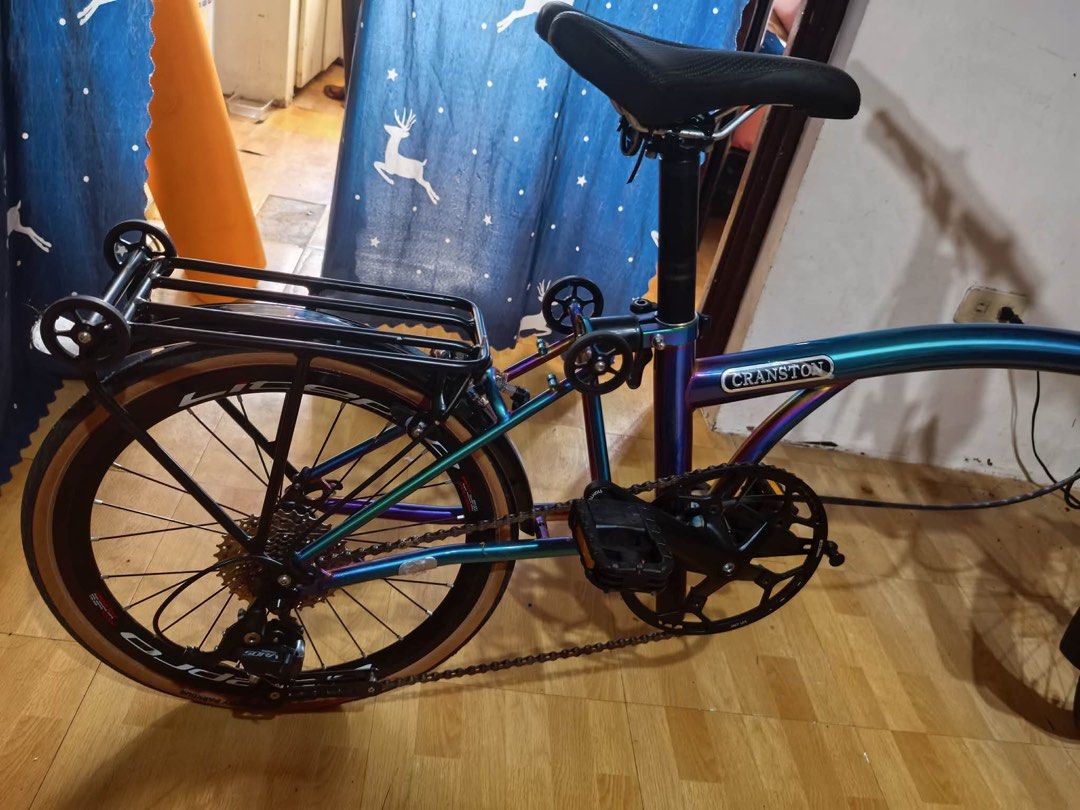 CRANSTON Folding Bike - Iridescent Frame (Category: Bicycles) located in Pasay City. Submitted by honeyyahh12 (Listing ID 1460751405, Image 2). Description: - Unique iridescent paint that shifts colors - Lightweight and easy to fold - Comes with a rear rack for extra storage - Tan sidewall tires for a stylish look - Perfect for commuting or casual rides - Ready for its next adventure! Price is negotiable but please refrain from lowballing. Orig P