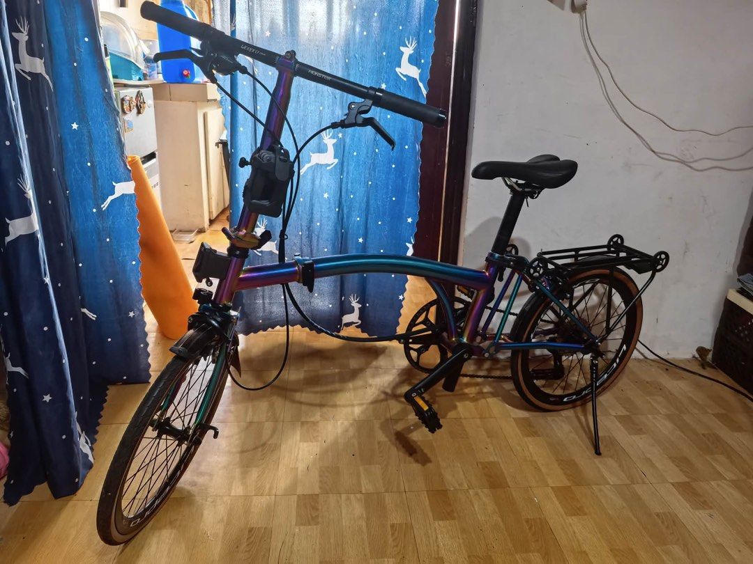 CRANSTON Folding Bike - Iridescent Frame (Category: Bicycles) located in Pasay City. Submitted by honeyyahh12 (Listing ID 1460751405, Image 1). Description: - Unique iridescent paint that shifts colors - Lightweight and easy to fold - Comes with a rear rack for extra storage - Tan sidewall tires for a stylish look - Perfect for commuting or casual rides - Ready for its next adventure! Price is negotiable but please refrain from lowballing. Orig P